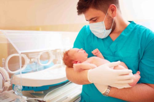 Doctor holding a newborn baby